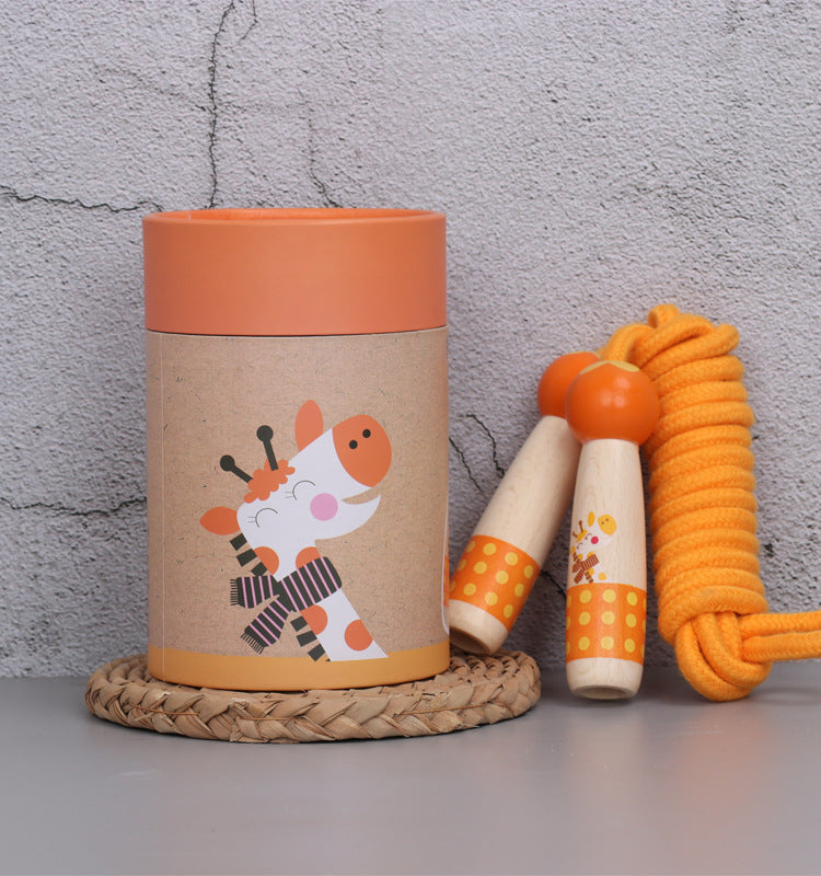 Giraffe wooden skipping rope with beech handles, shown with its kraft gift tube