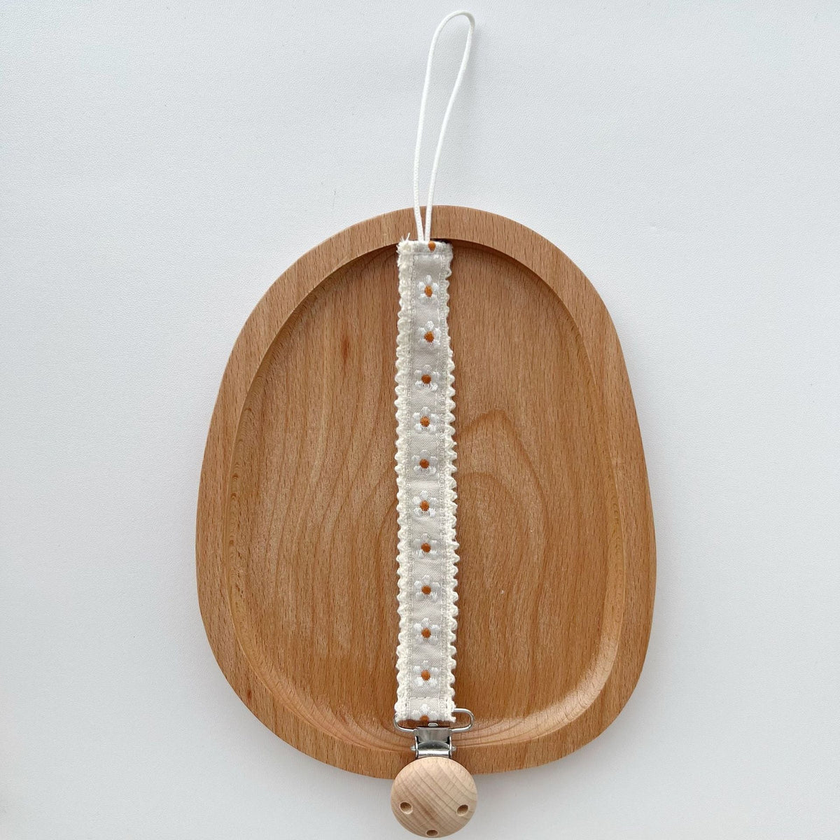 Floral Ribbon Dummy Clip, Lace Edge Soother Holder with Beech Wood Clip, 28.5 cm, 7 Designs, styled in a nursery setting